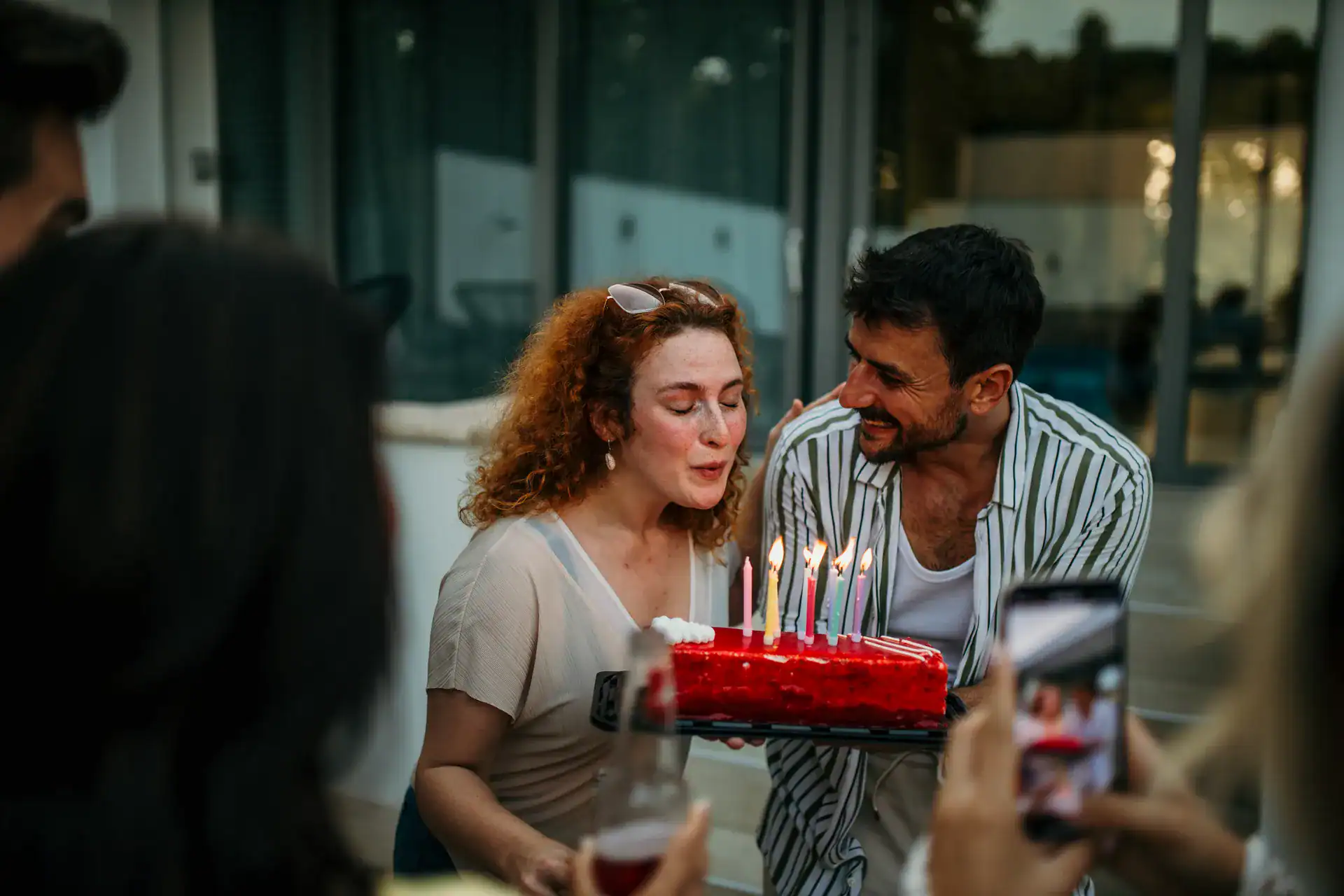 A couple celebrating with candles on a birthday cake